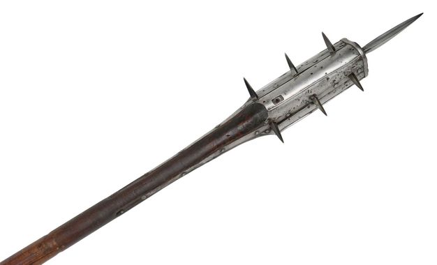 The top of this walking staff is capped in silver and has seven pointed barbs.