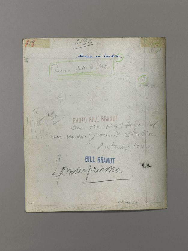 The back of a photograph has handwritten notes in pen and pencil. Two stamps read “Bill Brandt” and “Photo Bill Brandt”.
